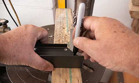 showing the fitting of a corner bracket into the end of a pre-drill length of No-weld framing.