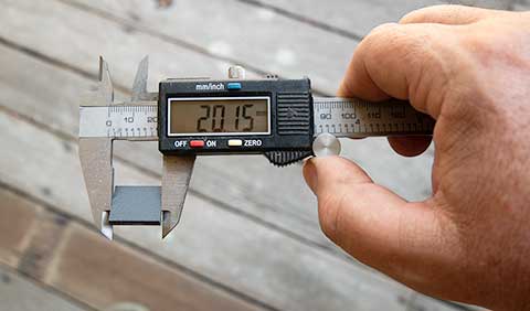 A spacer being measured with a pair of calipers